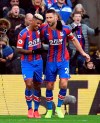 Crystal Palace's Patrick van Aanholt, left, celebrates scoring his side's first goal of the game against Newcastle, during their English Premier League soccer match at Selhurst Park in London, Saturday Feb. 22, 2020. (Kirsty O'Connor/PA via AP)