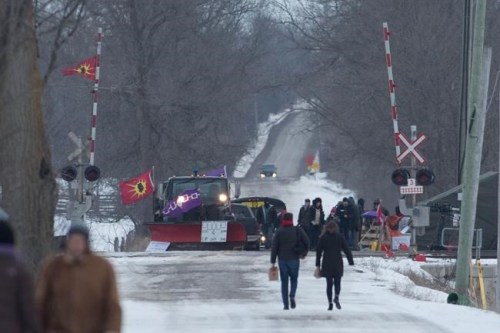 People arrive at the train track blockade in Tyendinaga Mohawk Territory near Belleville, Ontario, on Tuesday Feb. 11, 2020, in support of Wet'suwet'en's blockade of a natural gas pipeline in northern B.C. THE CANADIAN PRESS/Lars Hagberg