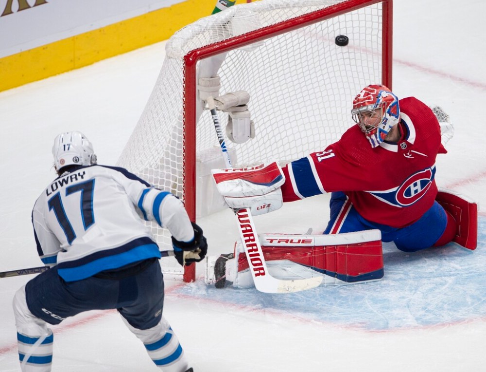 THE CANADIAN PRESS FILES/Ryan Remiorz
Winnipeg Jets' Adam Lowry scores on Montreal Canadiens goaltender Carey Price during Stanley Cup playoff hockey action in June.