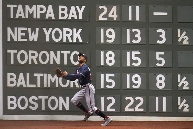 Atlanta Braves left fielder Nick Markakis tries to chase down a deep ball hit for a double by Boston Red Sox's Alex Verdugo during the third inning of a baseball game Monday, Aug. 31, 2020, in Boston. (AP Photo/Charles Krupa)