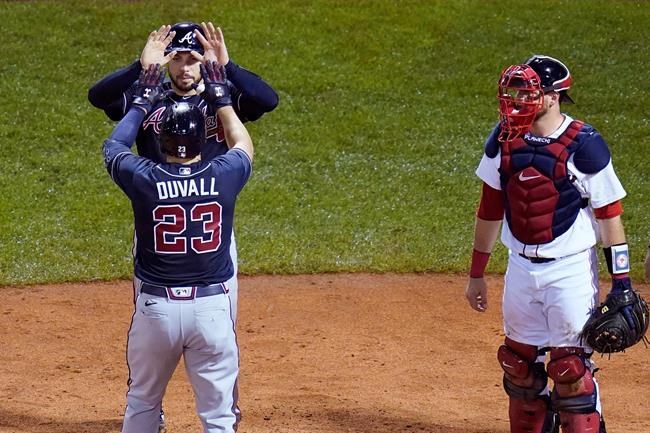 Atlanta Braves' Adam Duvall (23) is congratulated by Travis d'Arnaud, after his second home run of the game during the sixth inning of a baseball game, against the Boston Red Sox, Wednesday Sept. 2, 2020, in Boston. At right is Boston Red Sox catcher Kevin Plawecki. (AP Photo/Charles Krupa)