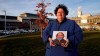 Laura Dilts, of Barre, Mass., holds a photograph of her 16-year-old son outside the Worcester Recovery Center, where he is a resident patient receiving assistance for his mental health, Monday, Nov. 23, 2020, in Worcester, Mass. The coronavirus pandemic has led to rising emergency room visits and longer waits for U.S. children and teens facing mental health issues. (AP Photo/Charles Krupa)