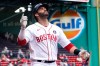 Boston Red Sox's J.D. Martinez celebrates his solo home run In the second inning of a baseball game against the Chicago White Sox at Fenway Park, Monday, April 19, 2021, in Boston. (AP Photo/Elise Amendola)