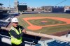 In this March 22, 2021, photo, Larry Lucchino, Chairman and Principal Owner of the Worcester Red Sox Triple-A baseball team, poses at Polar Park in Worcester, Mass., where construction work continues in preparation for the club's opening day in May. At an age when many ease into retirement, the 75-year-old three-time cancer survivor instead headed to the minor leagues for one more chance to run a baseball team and build it a new home. “I don’t think (retirement) is the way I’m wired,” Lucchino said this spring during an interview in the upper deck at the $118 million Polar Park. “I want to keep doing and being and making and contributing.” (AP Photo/Elise Amendola)