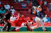 Seattle Mariners' Kyle Seager follows through on his two-run triple in front of Boston Red Sox's Kevin Plawecki during the second inning of a baseball game Saturday, April 24, 2021, in Boston. (AP Photo/Michael Dwyer)