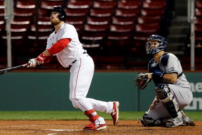 Boston Red Sox's Christian Arroyo watches his three-run home run in front of New York Yankees catcher Gary Sanchez during the fourth inning of a baseball game Friday, Sept. 18, 2020, in Boston. (AP Photo/Michael Dwyer)