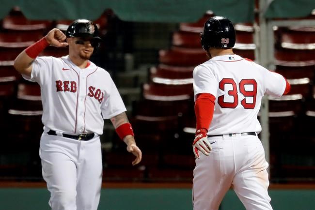 Boston Red Sox's Christian Arroyo (39) celebrates his three-run home run that also drove in Christian Vazquez, left, during the fourth inning of the team's baseball game against the New York Yankees, Friday, Sept. 18, 2020, in Boston. (AP Photo/Michael Dwyer)