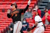 Baltimore Orioles' Ryan Mountcastle (6) follows through on his two-run double in front of Boston Red Sox's Christian Vazquez during the sixth inning of an opening day baseball game, Friday, April 2, 2021, in Boston. (AP Photo/Michael Dwyer)