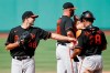 Baltimore Orioles' Richard Bleier (48) walks off the mound and reaches out to Pedro Severino (28) after being relieved by manager Brandon Hyde (18) during the eighth inning of a baseball game against the Boston Red Sox, Saturday, July 25, 2020, in Boston. (AP Photo/Michael Dwyer)