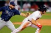 Tampa Bay Rays' Brandon Lowe tags Boston Red Sox's Andrew Benintendi on a run down at third base during the eighth inning of a baseball game, Tuesday, Aug. 11, 2020, in Boston. (AP Photo/Michael Dwyer)