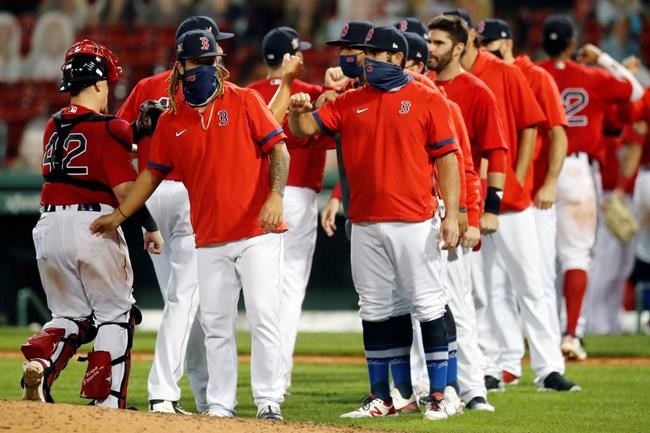 The Boston Red Sox celebrate after defeating the Washington Nationals during a baseball game, Saturday, Aug. 29, 2020, in Boston. (AP Photo/Michael Dwyer)