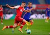 Leipzig's Kevin Kampl, right, and Freiburg's Roland Sallai challenge for the ball during the German Bundesliga soccer match between RB Leipzig and SC Freiburg in Leipzig, Germany, Saturday, Nov. 7, 2020. (Hendrik Schmidt/dpa via AP)