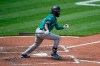 Seattle Mariners' J.P. Crawford follows through on a two run double against the Baltimore Orioles in the sixth inning of the first game of a baseball doubleheader, Thursday, April 15, 2021, in Baltimore. (AP Photo/Gail Burton)