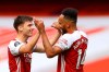 Arsenal's Kieran Tierney, left, is congratulated by Pierre-Emerick Aubameyang after scoring a goal during the first half of the English Premier League soccer match between Arsenal and Watford at Emirates Stadium in London, England, Sunday, July 26, 2020. (AP photo/Julian Finney, Pool)