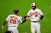 Baltimore Orioles Trey Mancini (16) is greeted by Pedro Severino (28) after hitting sixth inning solo home run during a baseball game Monday, May 10, 2021, in Baltimore. (AP Photo/Terrance Williams)