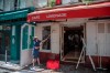 A man cleans the terrace of his restaurant in Paris, Friday, May 29, 2020, as France gradually lifts its Covid-19 lockdown. France is reopening next week its restaurants, bars and cafes starting next week as the country eases most restrictions amid the coronavirus crisis. (AP Photo/Michel Euler)