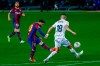 Barcelona's Lionel Messi, center, kicks the ball as he score the opening goal during the Spanish La Liga soccer match between FC Barcelona and Huesca at the Camp Nou stadium in Barcelona, Spain, Monday, March 15, 2021. (AP Photo/Joan Monfort)