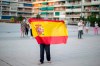 A woman holds a Spanish flag during a protest against the Spanish government amid the lockdown to prevent the spread of coronavirus in Alcorcon, Spain, Friday, May 22, 2020. The Spanish government is allowing Madrid and Barcelona to ease their lockdown measures, which were introduced to fight the coronavirus pandemic. (AP Photo/Manu Fernandez)