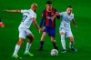 Barcelona's Pedri, center, duels for the balls with Huesca's Mikel Rico, left, and Huesca's David Ferreiro during the Spanish La Liga soccer match between FC Barcelona and Huesca at the Camp Nou stadium in Barcelona, Spain, Monday, March 15, 2021. (AP Photo/Joan Monfort)