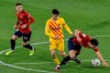 Barcelona's Pedri, center, fights for the ball with Osasuna's Lucas Torro during the Spanish La Liga soccer match between Osasuna and FC Barcelona at El Sadar stadium in Pamplona, Spain, Saturday, March 6, 2021. (AP Photo/Alvaro Barrientos)