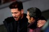 Atletico Madrid's head coach Diego Simeone, left, talks with FC Barcelona's head coach Ernesto Valverde during a Spanish La Liga soccer match between Atletico Madrid and FC Barcelona at Wanda Metropolitano stadium in Madrid, Spain, Sunday, Dec. 1, 2019. (AP Photo/Manu Fernandez)
