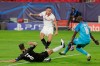 Sevilla's Lucas Ocampos, center, vies for the ball with Rennes' Damien Da Silva, left and Rennes' goalkeeper Alfred Gomis during the Champions League group E soccer match between Sevilla and Rennes at the Ramon Sanchez Pijuan stadium in Seville, Spain, Wednesday, Oct. 28, 2020. (AP Photo/Angel Fernandez)