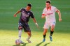 Real Madrid's Rodrygo Silva de Goes, left, challenges for the ball with Sevilla's Munir El Haddadi during the Spanish La Liga soccer match between Sevilla and Real Madrid at the Ramon Sanchez Pizjuan stadium in Seville, Spain, Saturday Dec. 5, 2020. (AP Photo/Angel Fernandez)
