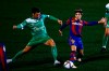 Barcelona's Riqui Puig, right, vies for the ball with Cornella's Kevin Presa during a Spanish Copa del Rey round of 32 soccer match between Cornella and FC Barcelona at the Nou Municipal stadium in Cornella, Spain, Thursday, Jan. 21, 2021. (AP Photo/Joan Monfort)