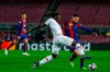 Barcelona's Jordi Alba, right, fights for the ball with PSG's Moise Kean15 during the Champions League round of 16, first leg soccer match between FC Barcelona and Paris Saint-Germain at the Camp Nou stadium in Barcelona, Spain, Tuesday, Feb. 16, 2021. (AP Photo/Joan Monfort)