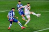 Real Madrid's Karim Benzema, right, tries a shot during the Spanish La Liga soccer match between Alaves and Real Madrid at Mendizorroza stadium in Vitoria, Spain, Saturday, Jan. 23, 2021. (AP Photo/Alvaro Barrientos)