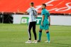 A supporter, left, invades the pitch and attempts to take a selfie with FC Barcelona's Jordi Alba during the Spanish La Liga soccer match between Mallorca and FC Barcelona at Son Moix Stadium in Palma de Mallorca, Spain, Saturday, June 13, 2020. With virtual crowds, daily matches and lots of testing for the coronavirus, soccer is coming back to Spain. The Spanish league resumes this week more than three months after it was suspended because of the COVID-19 pandemic. (AP Photo/Francisco Ubilla)