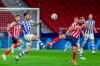 Alaves' Joselu, left, fights for the ball with Atletico Madrid's Yannick Carrasco during the Spanish La Liga soccer match between Atletico Madrid and Alaves at the Wanda Metropolitano stadium in Madrid, Spain, Sunday, March 21, 2021. (AP Photo/Manu Fernandez)