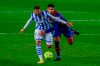 Real Sociedad's Willian Jose, left, vies for the ball with Barcelona's Ronald Araujo during the Spanish La Liga soccer match between FC Barcelona and Real Sociedad at the Camp Nou stadium in Barcelona, Spain, Wednesday, Dec. 16, 2020. (AP Photo/Joan Monfort)