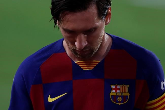Barcelona's Lionel Messi looks down during the Spanish La Liga soccer match between Sevilla and FC Barcelona at the Ramon Sanchez-Pizjuan stadium in Seville, Spain, Friday, June 19, 2020. (AP Photo/Angel Fernandez)
