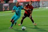 FC Barcelona's Martin Braithwaite, left, vies for the ball with Marllorca's Martin Valjent, right, during the Spanish La Liga soccer match between Mallorca and FC Barcelona at Son Moix Stadium in Palma de Mallorca, Spain, Saturday, June 13, 2020. With virtual crowds, daily matches and lots of testing for the coronavirus, soccer is coming back to Spain. The Spanish league resumes this week more than three months after it was suspended because of the COVID-19 pandemic. (AP Photo/Francisco Ubilla)
