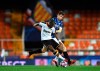 Valencia's Geoffrey Kondogbia, left, duels for the ball with Atalanta's Marten de Roon during the Champions League round of 16 second leg soccer match between Valencia and Atalanta in Valencia, Spain, Tuesday March 10, 2020. The match is being in an empty stadium because of the coronavirus outbreak. (UEFA via AP)