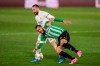 Real Madrid's Dani Carvajal, left, vies for the ball with Betis' Borja Iglesias during the Spanish La Liga soccer match between Real Madrid and Betis at the Alfredo di Stefano stadium in Madrid, Spain, Saturday, April 24, 2021. (AP Photo/Bernat Armangue)