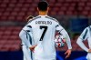 Juventus' Cristiano Ronaldo holds a ball before socoring a penalty kick during the Champions League group G soccer match between FC Barcelona and Juventus at the Camp Nou stadium in Barcelona, Spain, Tuesday, Dec. 8, 2020. (AP Photo/Joan Monfort)