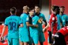 Barcelona's Lionel Messi, center, celebrates with his teammates after scoring his side's fourth goal during the Spanish La Liga soccer match between Mallorca and FC Barcelona at Son Moix Stadium in Palma de Mallorca, Spain, Saturday, June 13, 2020. With virtual crowds, daily matches and lots of testing for the coronavirus, soccer is coming back to Spain. The Spanish league resumes this week more than three months after it was suspended because of the COVID-19 pandemic. (AP Photo/Francisco Ubilla)