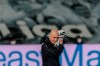 Real Madrid's head coach Zinedine Zidane wipes the water of the rain of his face with a towel during the Spanish La Liga soccer match between Real Madrid and Betis at the Alfredo di Stefano stadium in Madrid, Spain, Saturday, April 24, 2021. (AP Photo/Bernat Armangue)