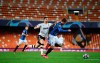 Atalanta's Hans Hateboer, right, vies for the ball with Valencia's Goncalo Guedes during the Champions League round of 16 second leg soccer match between Valencia and Atalanta in Valencia, Spain, Tuesday March 10, 2020. The match is being in an empty stadium because of the coronavirus outbreak. (UEFA via AP)