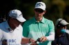 Dylan Frittelli, right, of South Africa, confers with his caddie on the 17th hole during the first round of the RBC Heritage golf tournament Thursday, June 18, 2020, in Hilton Head Island, S.C. (AP Photo/Gerry Broome)