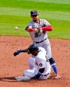 Minnesota Twins second baseman Ildemaro Vargas throws over Detroit Tigers' Niko Goodrum for a double play hit into by Tigers' Jacoby Jones during the second inning of the first baseball game of a doubleheader, Saturday, Aug. 29, 2020, in Detroit. (AP Photo/Carlos Osorio)