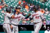 Minnesota Twins designated hitter Nelson Cruz (23) is greeted by Luis Arraez, left, and Andrelton Simmons after his grand slam during the second inning of a baseball game against the Detroit Tigers, Monday, April 5, 2021, in Detroit. (AP Photo/Carlos Osorio)