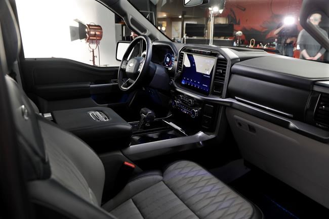 In a photo from, Wednesday, June 24, 2020, the interior on new 2021 Ford F-150 truck is photographed in Ferndale, Mich. Six years ago, Ford bet big on the top-selling vehicle in America, rolling out a radical new version of the F-Series pickup with a lighter aluminum body instead of steel. Now it's time for another revamp, and Ford is playing it safe. On the outside, the truck changes little. The biggest differences are a gas-electric hybrid version, internet connectivity, and a revamped interior that turns the truck into more of a rolling office or even a place to nap. (AP Photo/Carlos Osorio)