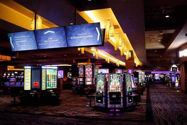 Video slot machines are seen at the MGM Grand Detroit casino, Wednesday, Aug. 5, 2020, in Detroit. Detroit's three casinos will start reopening Wednesday under new governor-mandated capacity restrictions, months after closing for the coronavirus pandemic. MotorCity Casino Hotel and the Greektown Casino-Hotel. opened Wednesday. MGM Grand Detroit will open for invite-only VIP customers Wednesday and Thursday, and at 10 a.m. Friday for the general public. (AP Photo/Carlos Osorio)