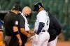 Detroit Tigers second baseman Jonathan Schoop has his hand checked after being hit by a pitch during the fourth inning of the team's baseball game against the Milwaukee Brewers, Tuesday, Sept. 8, 2020, in Detroit. (AP Photo/Carlos Osorio)