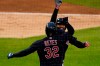 Cleveland Indians' Domingo Santana is greeted by Franmil Reyes after hitting a three-run home run during the fourth inning of a baseball game against the Detroit Tigers, Friday, Aug. 14, 2020, in Detroit. (AP Photo/Carlos Osorio)