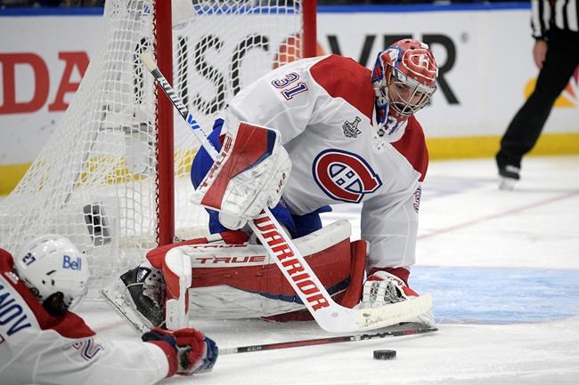 Montreal Canadiens goaltender Carey Price (31) plays the puck during the first period in Game 5 of the NHL hockey Stanley Cup finals against the Tampa Bay Lightning, Wednesday, July 7, 2021, in Tampa, Fla. (AP Photo/Phelan Ebenhack)