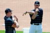 Detroit Tigers' Spencer Torkelson, right, stretches with fellow infielder Frank Schwindel during baseball training camp at Comerica Park, Saturday, July 4, 2020, in Detroit. (AP Photo/Duane Burleson)
